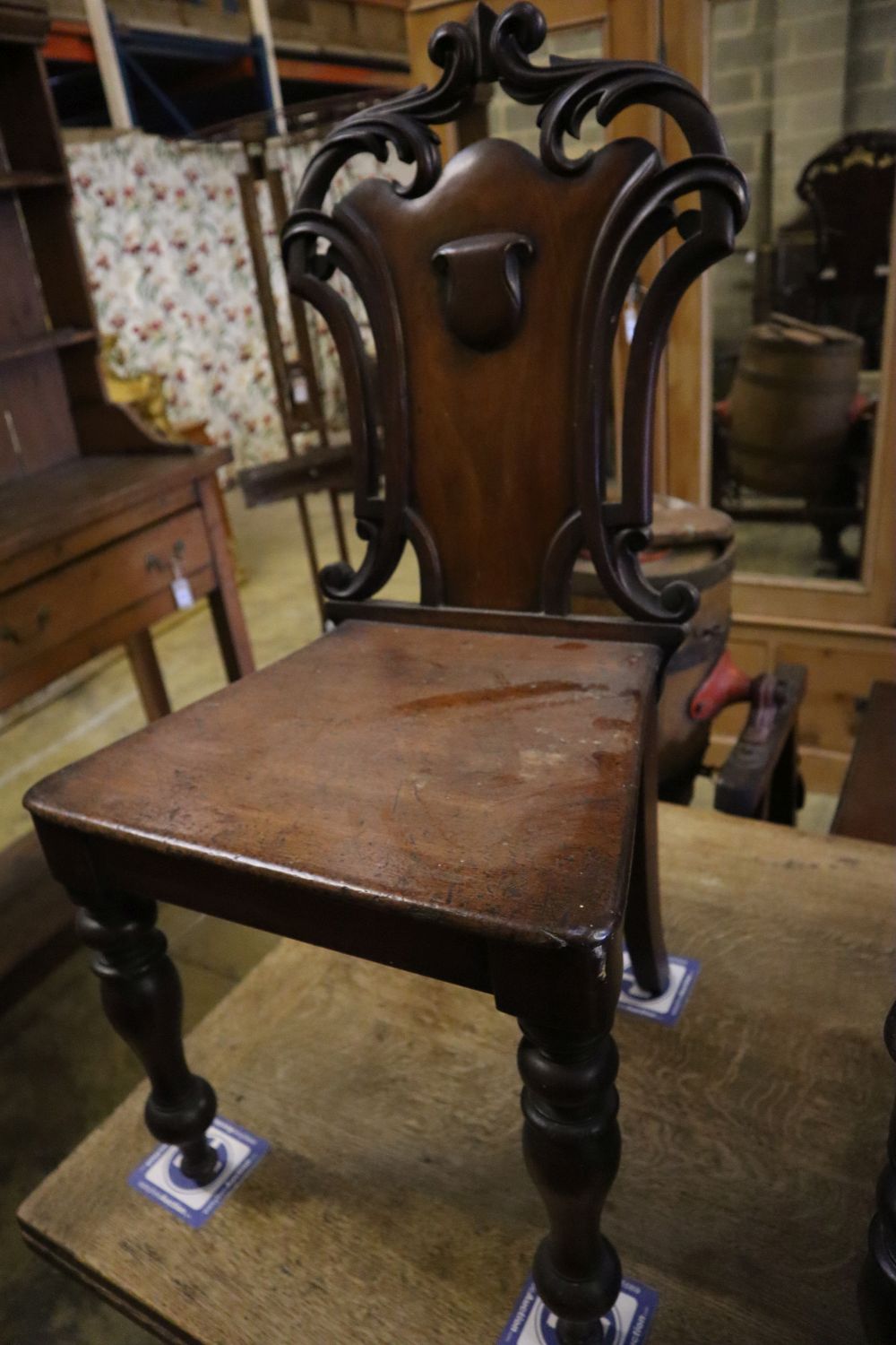 A pair of Victorian mahogany hall chairs (one a.f.)